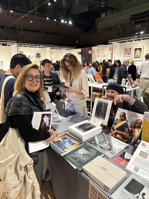 Santa Bannon was pointing out some of the books for sale to a customer at the Photo Review table at AIPAD. The Photo Review is celebrating its 50th Anniversary this year. Santa Bannon was pointing out some of the books for sale to a customer at the Photo Review table at AIPAD. The Photo Review is celebrating its 50th Anniversary this year.